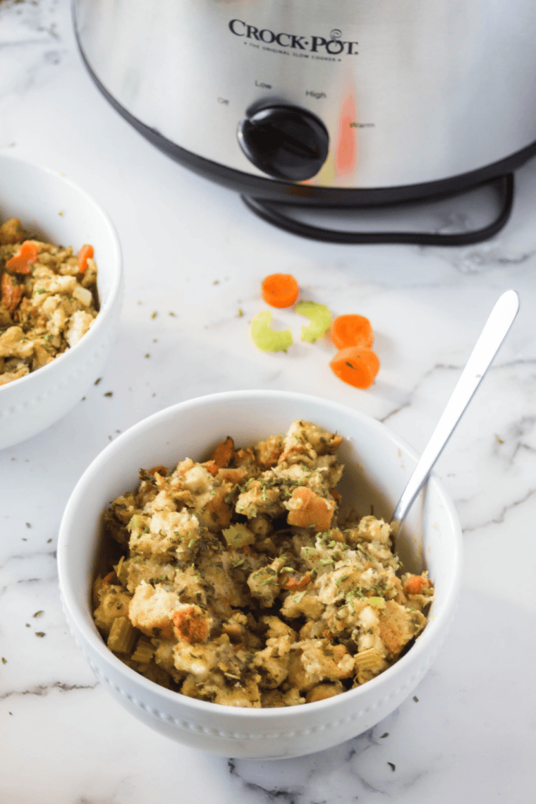 Crockpot stovetop stuffing served in a white bowl with a spoon