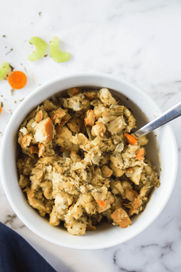 Close up of fluffy crockpot stovetop stuffing on a serving spoon