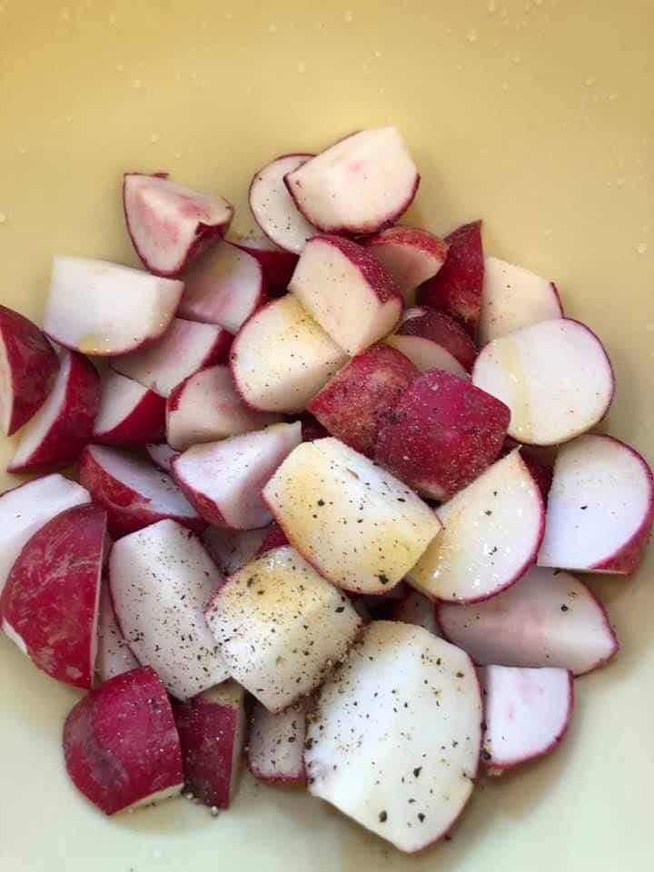 Step 3: SeasonThe Radishes
Add your sliced radishes, olive oil, salt, and pepper to a medium mixing bowl, and toss to coat.

