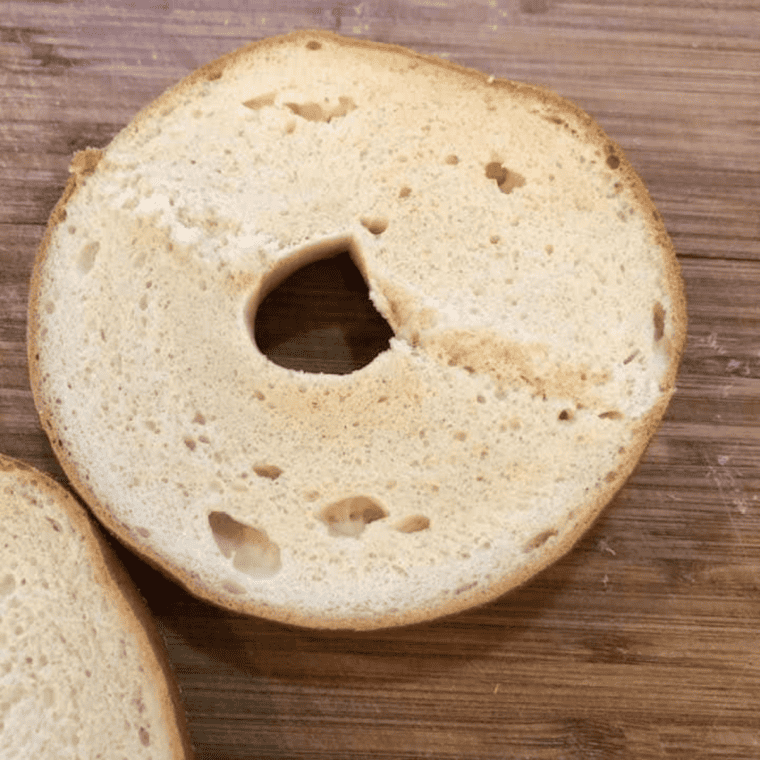 overhead process shot: bagel sliced in half for air fryer pizza bagels