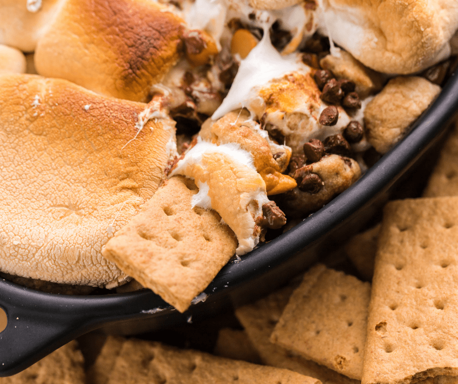 extreme closeup: scooping air fryer smores dip with a graham cracker