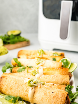 Crispy air fryer beef and bean taquitos filled with seasoned ground beef, refried beans, and melted cheese served with salsa