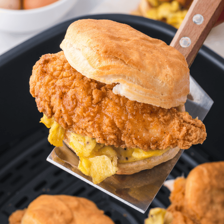 Homemade buttermilk biscuits cooked in an air fryer basket, golden brown on top with soft flaky layers inside.