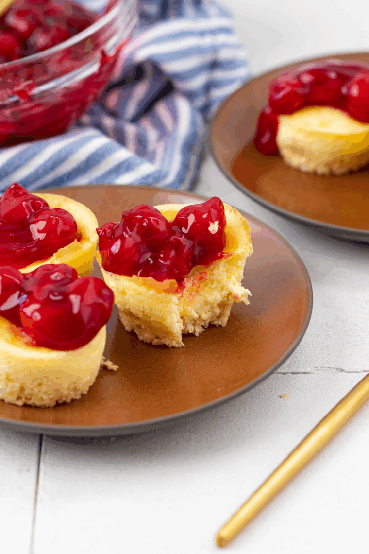 Air fryer mini cheesecakes with creamy filling and cherry topping.