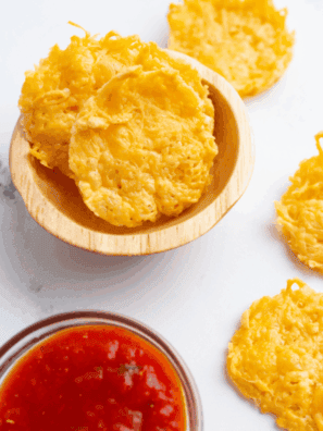 Crispy golden Parmesan crisps fresh from the air fryer on a plate.