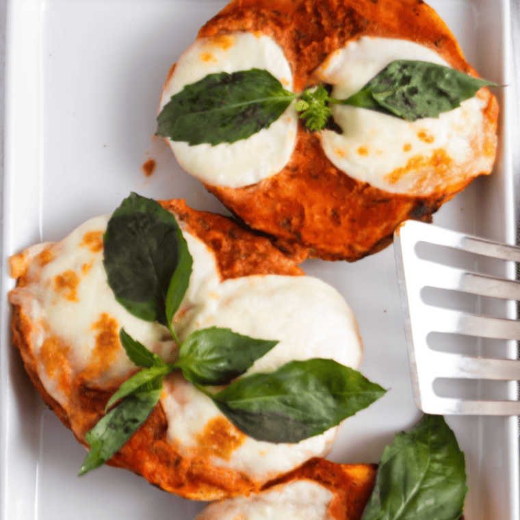 overhead closeup: air fryer pizza bagels with mozzarella cheese and basil on top