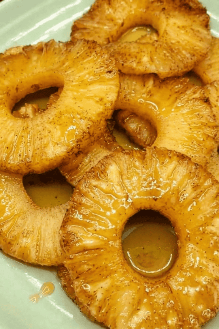 Air Fryer Rum Soaked Pineapple rings caramelized and golden on a serving plate.
