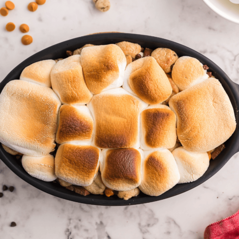 overhead closeup: gooey air fryer s'mores dip with toasted marshmallows on top