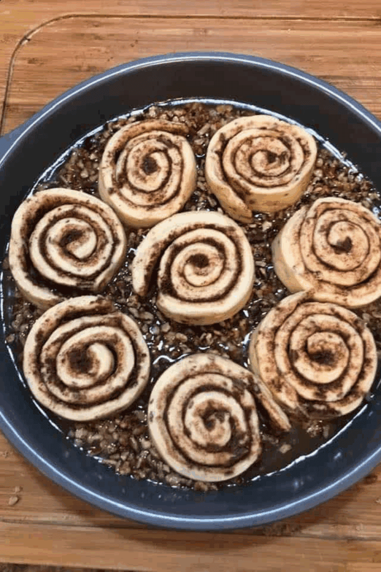 Place the cinnamon rolls on top of the gooey topping.
