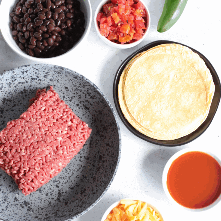 Ingredients needed for Air Fryer Ground Beef Enchiladas on kitchen table.