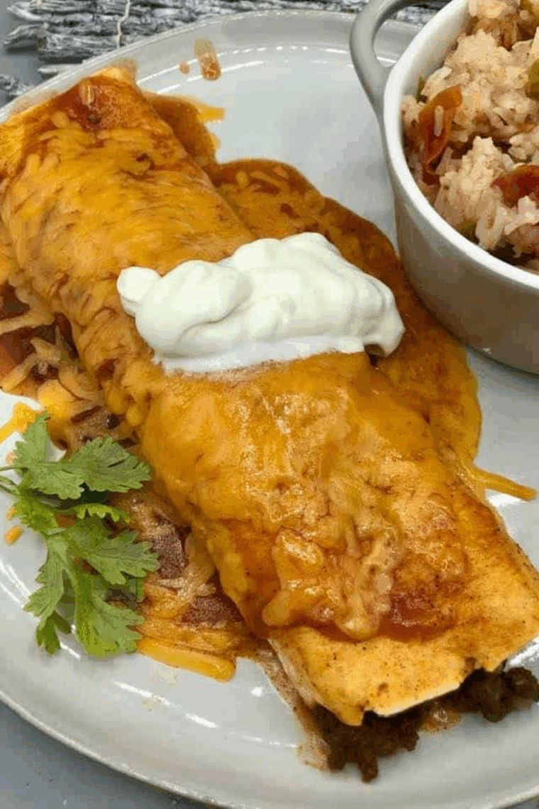 Air fryer enchiladas filled with seasoned ground beef, topped with melted cheese and enchilada sauce.