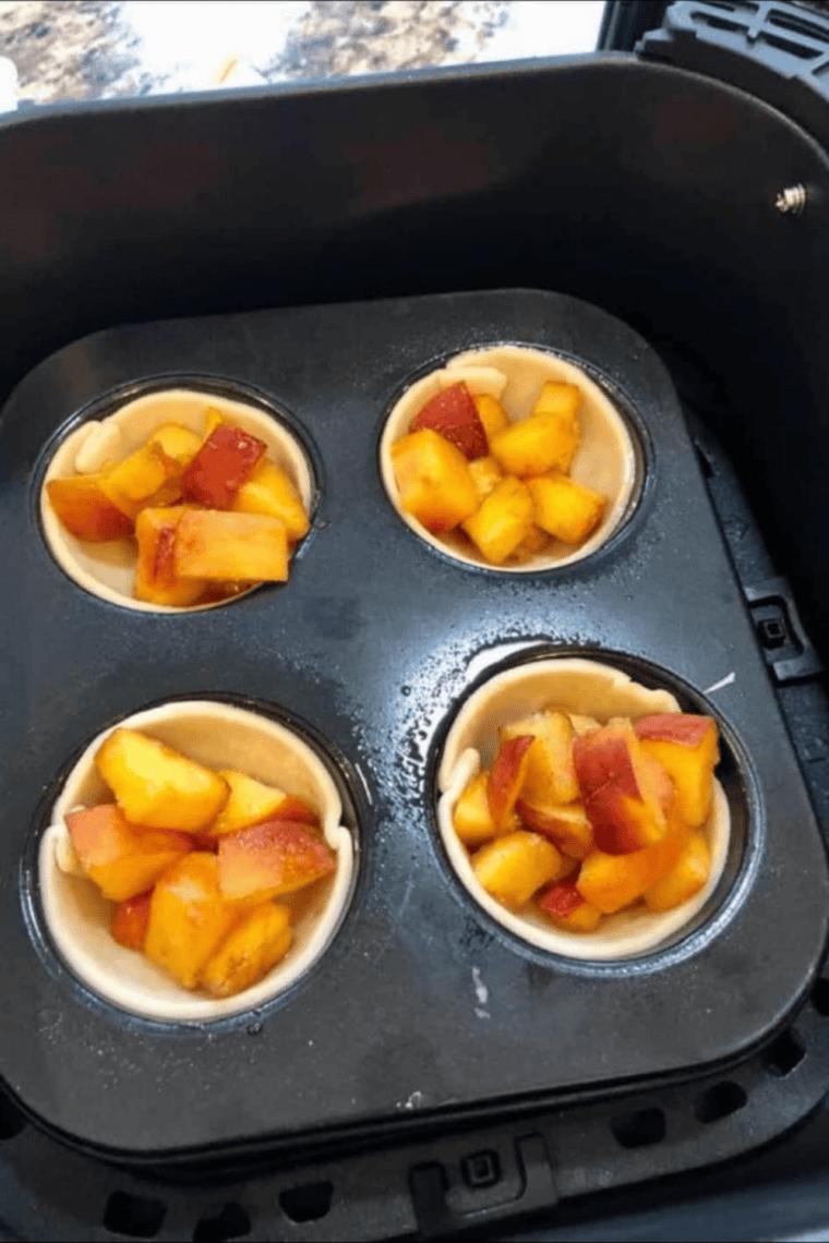 Easy Air Fryer Muffin Tin Peach Pies with golden crusts and sweet, juicy peach filling, baked in a muffin tin.