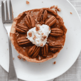 Air fryer pecan pie on a dessert plate with one slice removed
