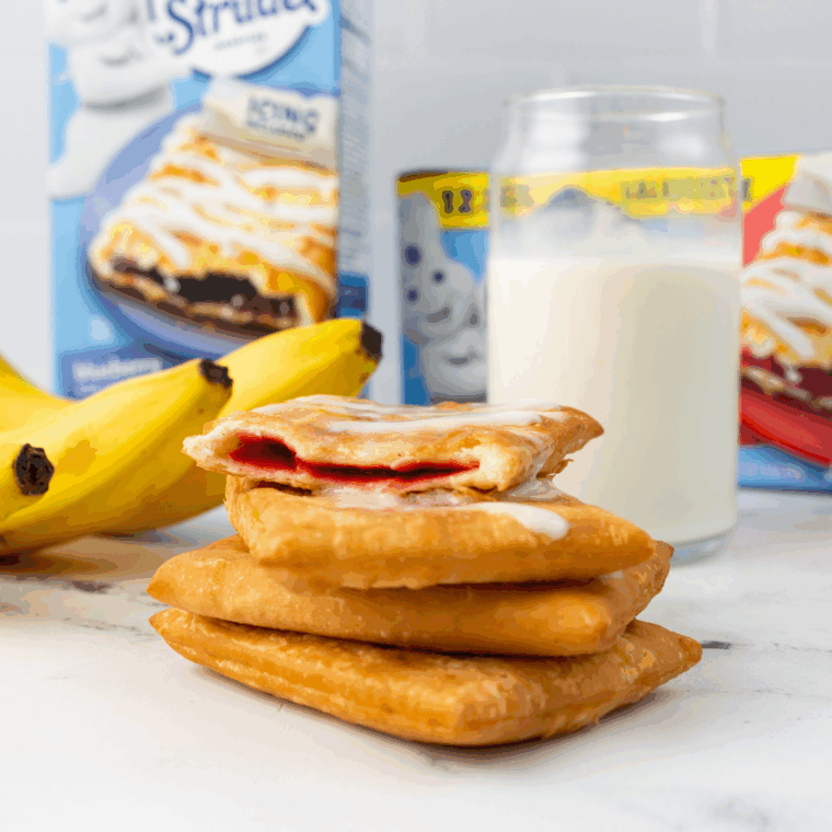 Perfectly flaky, golden Air Fryer Toaster Strudel on a plate, drizzled with frosting.