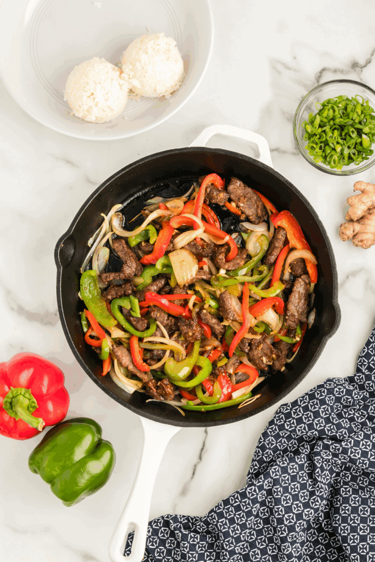 Whisking together soy-free stir fry sauce with coconut aminos, garlic, ginger, and honey in a small bowl.