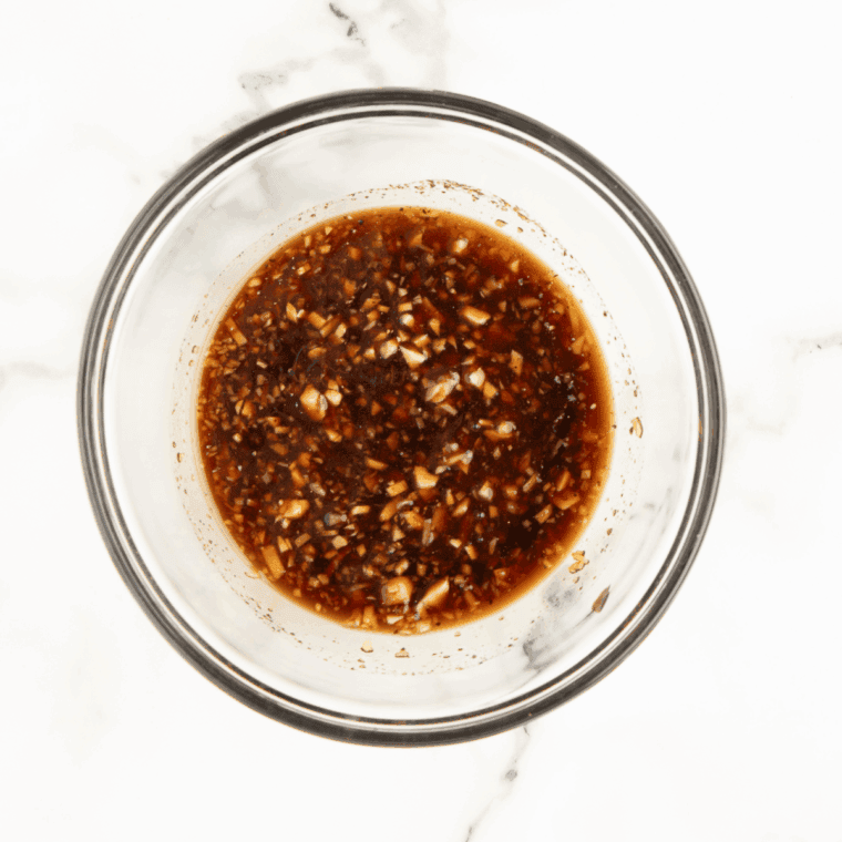Small bowl of soy-free stir fry sauce ingredients being whisked together until smooth.