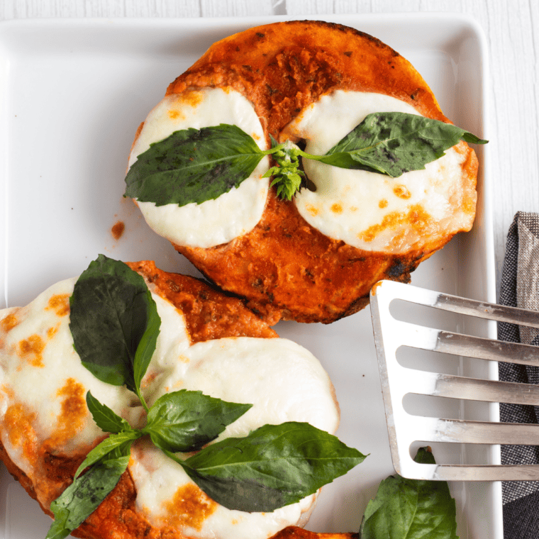 overhead closeup: pizza bagels air fryer recipe with cheese and basil