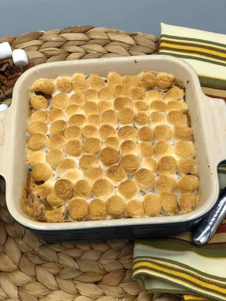 Sweet potato casserole on top of table cloth. 