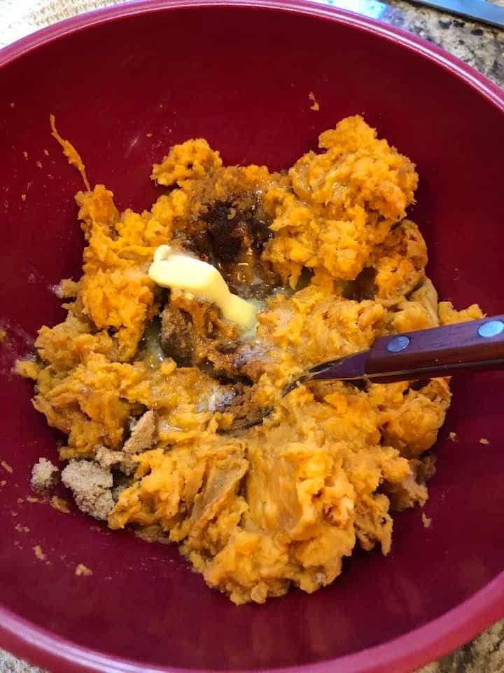 Smashed sweet potato other ingredients in a bowl. 