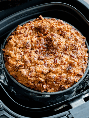 Golden apple cake sliced on a plate, baked in the air fryer with just 4 simple ingredients.