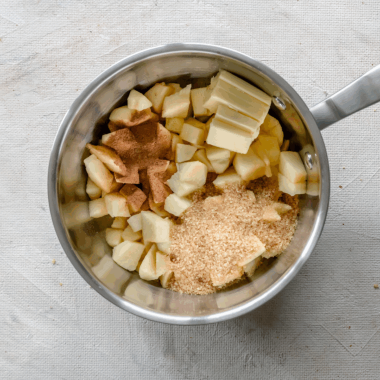 Brown sugar and eggs being whisked together in a large mixing bowl until smooth.