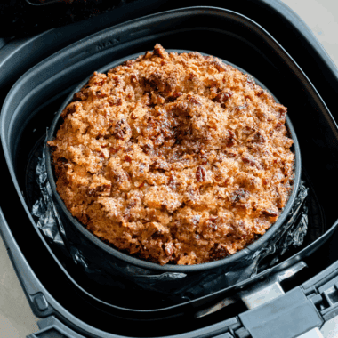 Golden apple cake sliced on a plate, baked in the air fryer with just 4 simple ingredients.