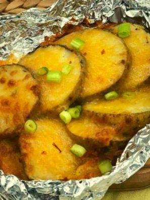 Air Fryer Cheesy Potatoes Foil Packet opened and showing the reader the melted cheese on the potatoes.