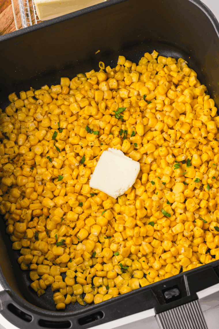 Golden roasted air fryer frozen corn kernels served in a white bowl, perfectly crispy and ready to enjoy.