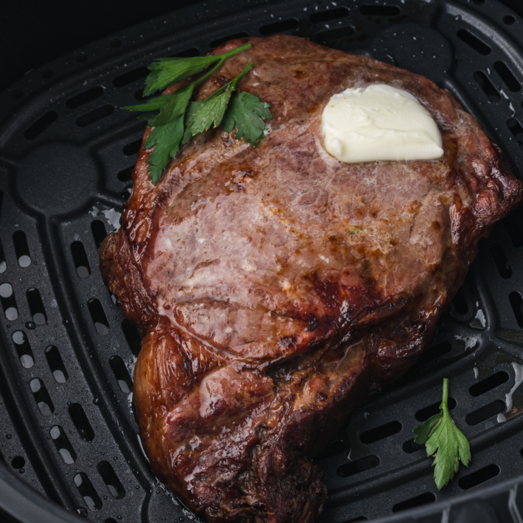 Air fryer cooking a frozen steak to a crispy and tender finish.