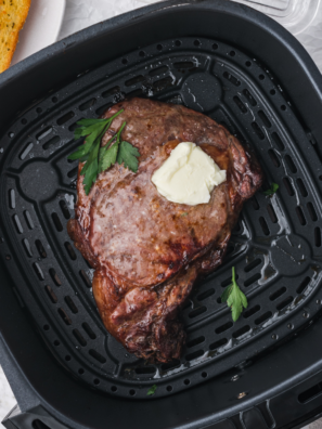 Frozen steak cooking in the air fryer for a crispy, tender result.