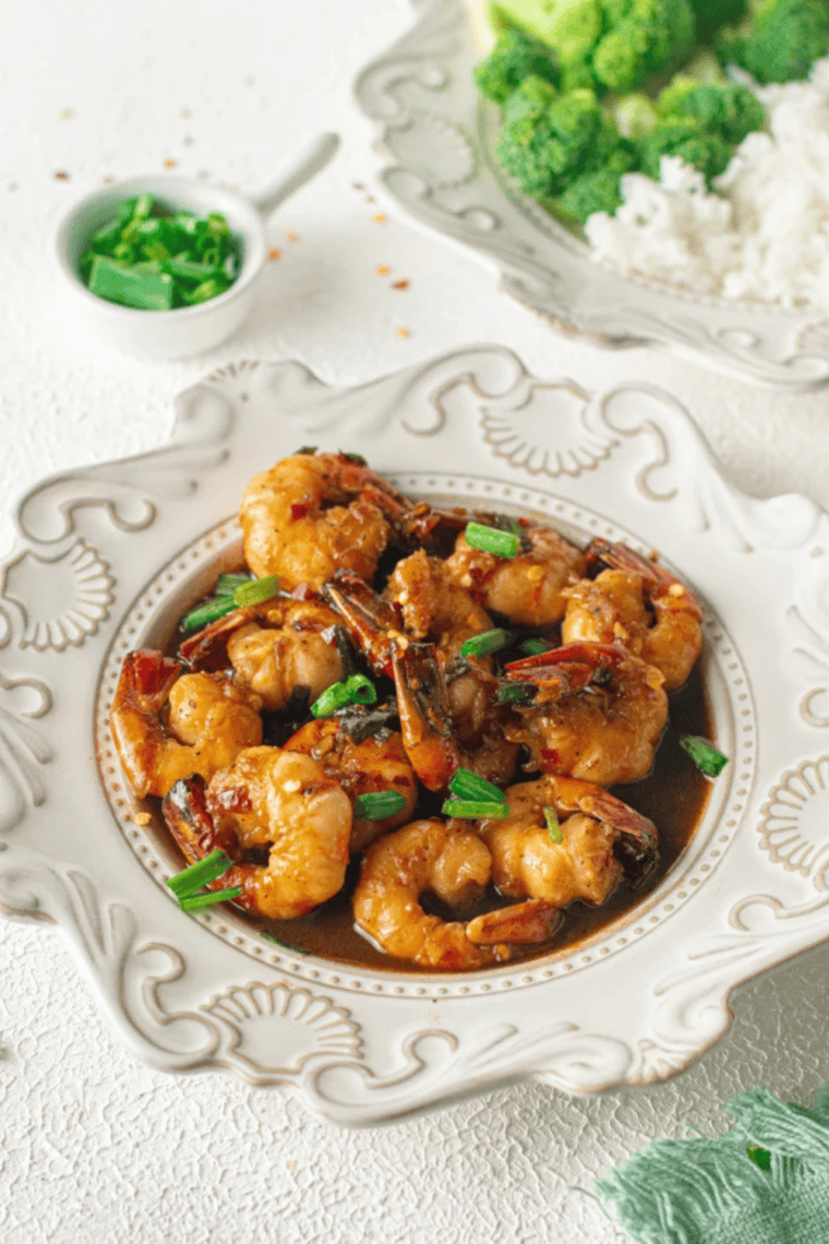 Air fryer honey garlic shrimp coated in a sticky honey garlic glaze, topped with green onions