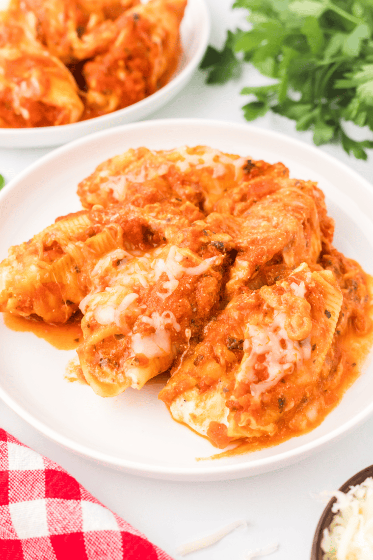 Air fryer stuffed shells with ricotta and mozzarella cheese, topped with pasta sauce.