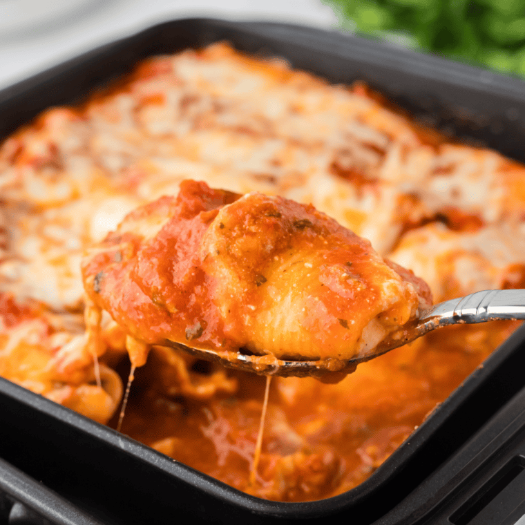 Air fryer Italian baked stuffed shells filled with ricotta, mozzarella, and marinara sauce, topped with melted cheese, ready to serve.