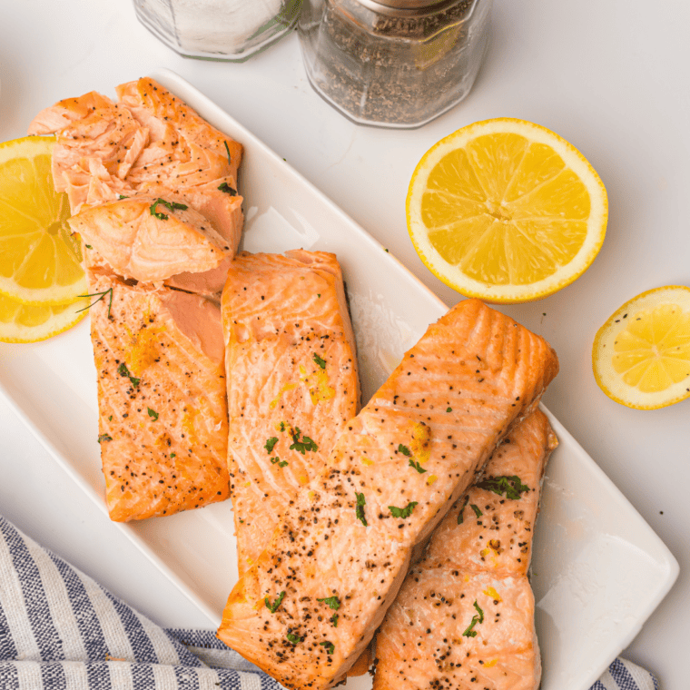 Finished air fryer lemon Dijon salmon plated with lemon slices
