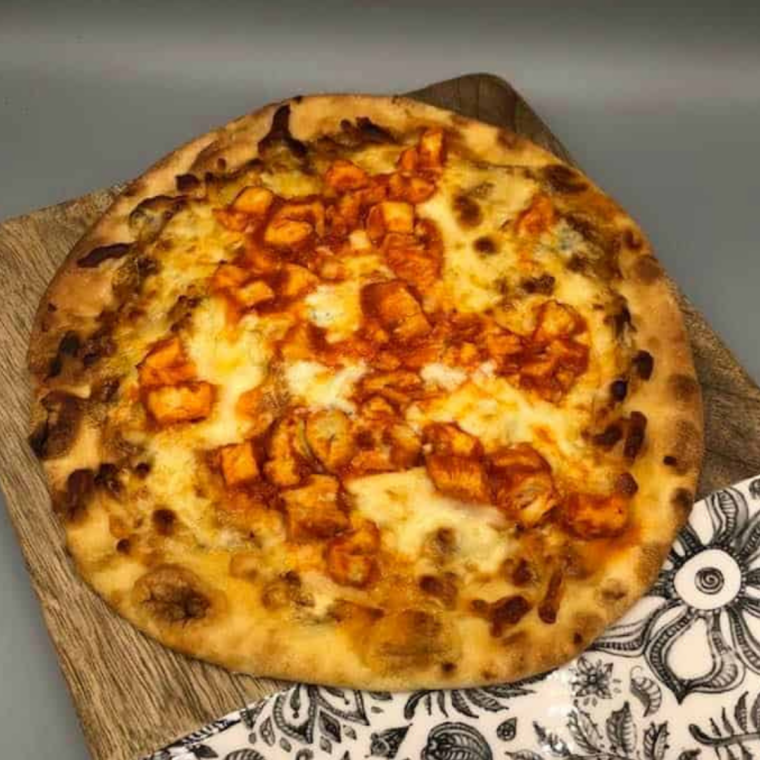 Air Fryer Naan Buffalo Chicken Pizza with spicy buffalo chicken and melted mozzarella cheese
