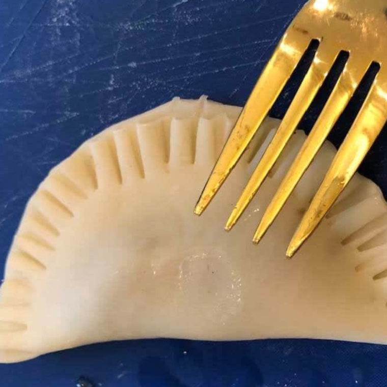 Sealing the edges of Air Fryer Pecan Pie Hand Pies with a fork