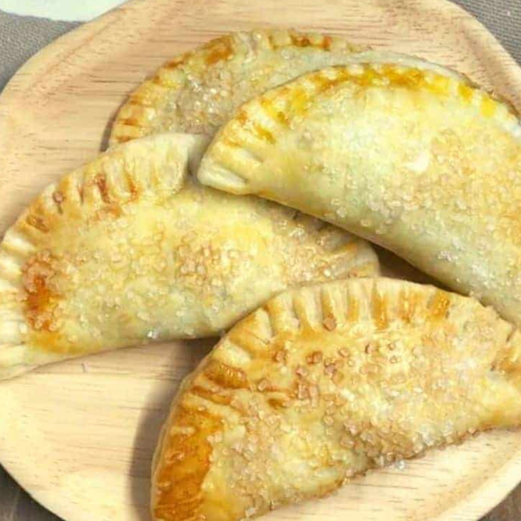 Plate of golden-brown Air Fryer Pecan Pie Hand Pies, beautifully arranged and ready to serve.