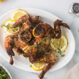 Crispy golden air fryer spatchcock chicken on a cutting board
