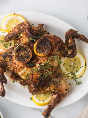 Crispy golden air fryer spatchcock chicken on a cutting board
