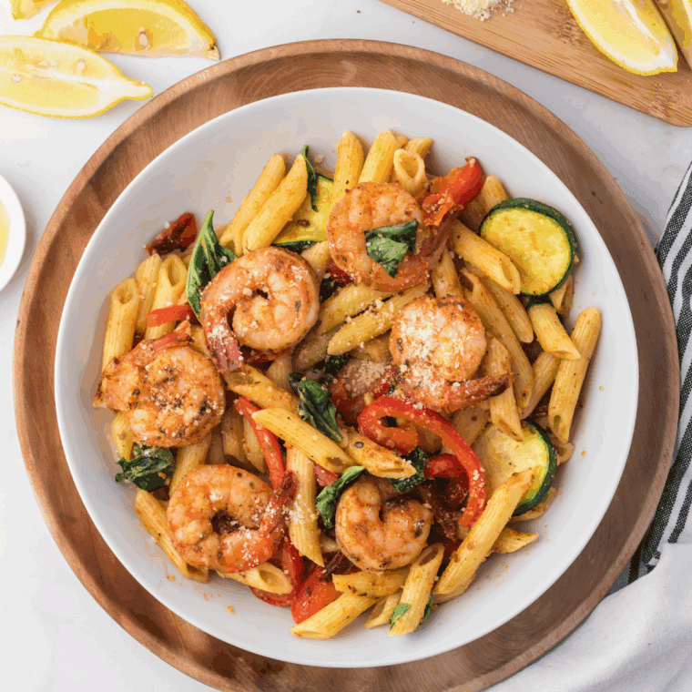Texas Roadhouse-style grilled shrimp skewers with seasoning and lemon slices on a plate.