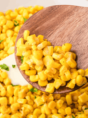 Golden roasted frozen corn kernels cooked in the air fryer, served in a white bowl and ready to enjoy.