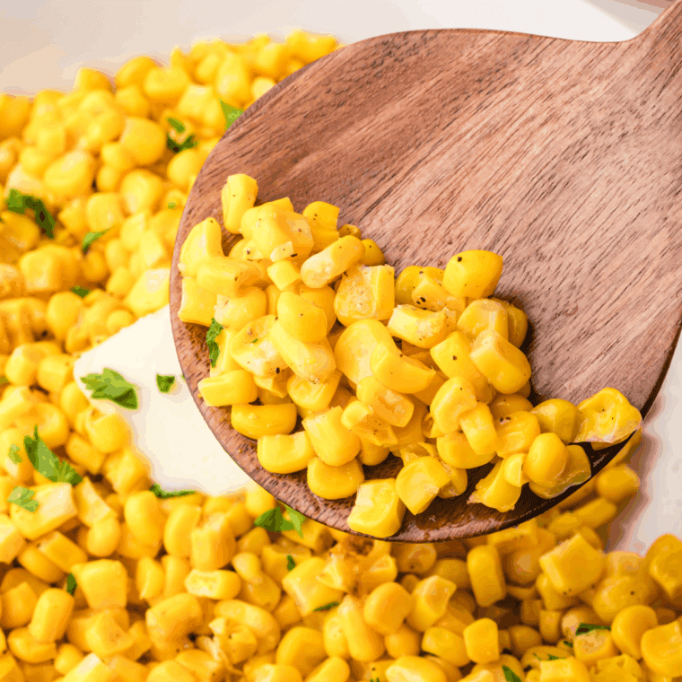 Golden roasted frozen corn kernels cooked in the air fryer, served in a white bowl and ready to enjoy.