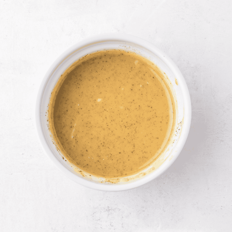 Whisking honey, lemon juice, garlic, and soy sauce into a glaze for honey lemon salmon