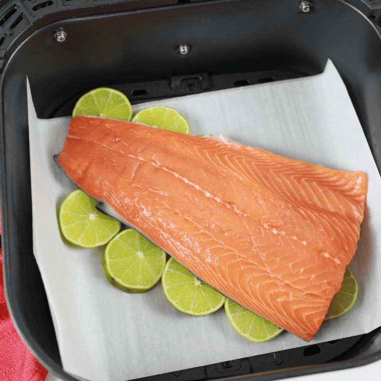 Brushing salmon fillets with olive oil and seasoning with salt and pepper