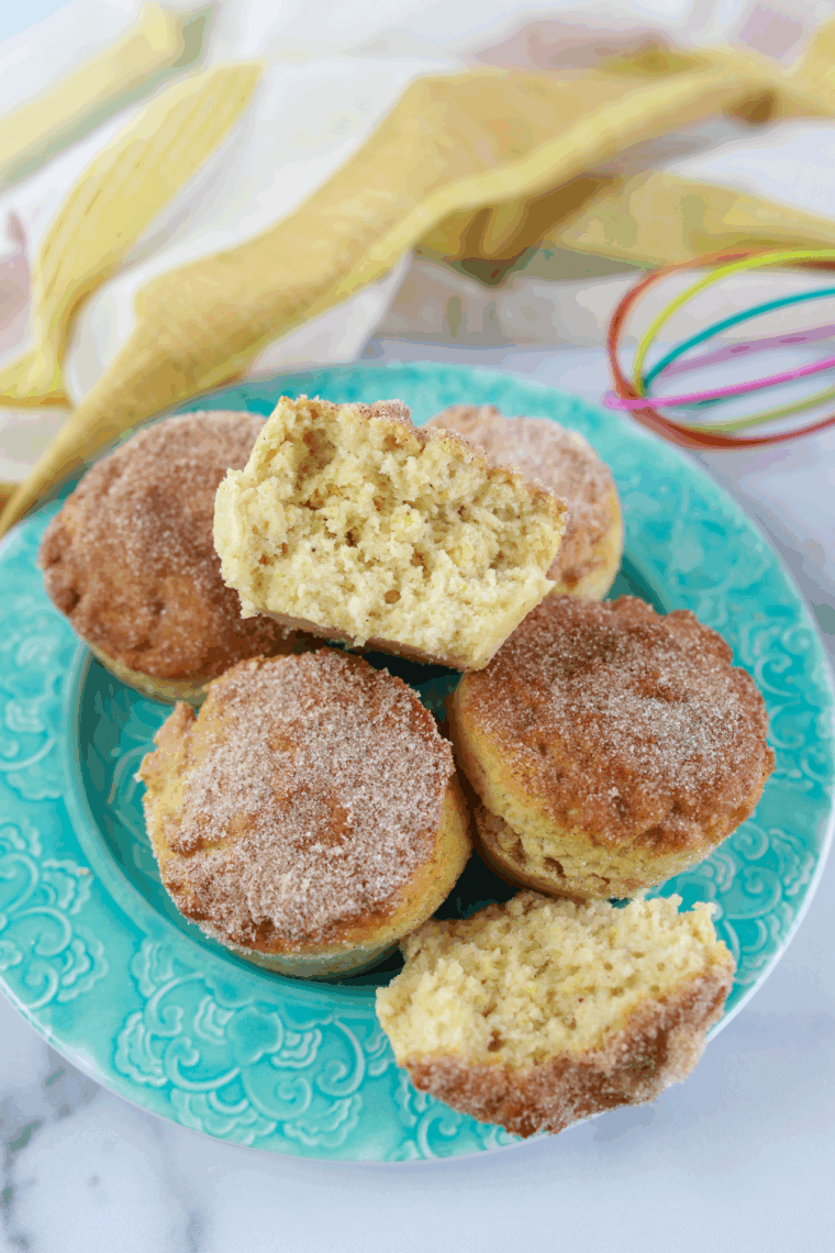 Golden air fryer cinnamon sugar donut muffins coated in sweet cinnamon-sugar