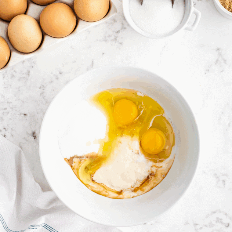 Whisking oil, egg, vanilla extract, and buttermilk together in a separate bowl