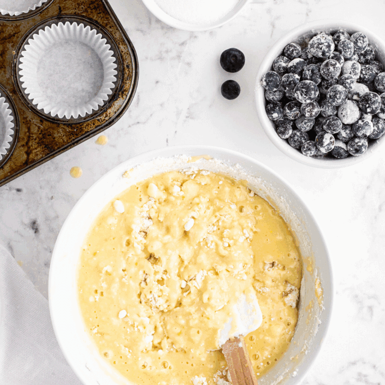 Combining wet ingredients into dry ingredients to form smooth muffin batter