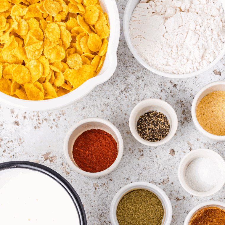 Ingredients needed for Air Fryer Cornflake Chicken Tenders on kitchen table.