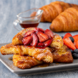 Crisp, buttery air fryer croissant french toast with roasted strawberries. Ready in 18 minutes, with shattery caramelized edges and a custardy center.