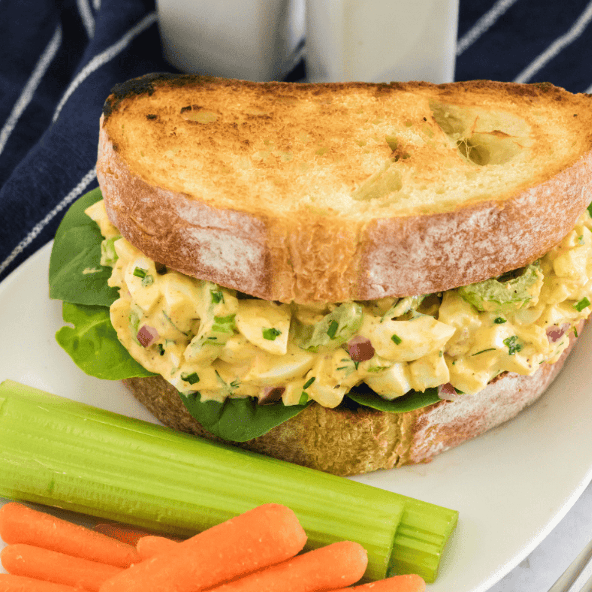 Creamy homemade egg salad made with air fryer eggs, served on toasted bread with lettuce.